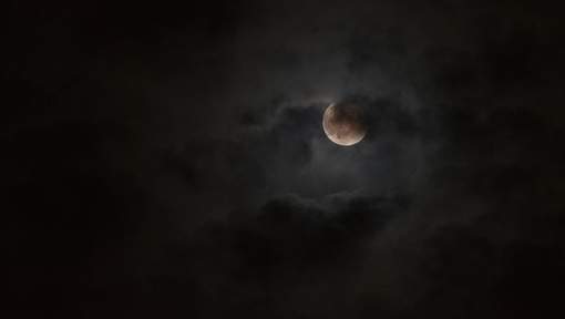 Moon glowing in night sky