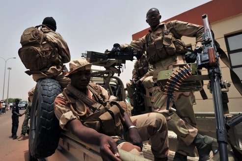 Malian military gather on a vehicle at Bamako airport on March 29, 2012 after a meeting of west African leaders to seek a return to democratic rule in Mali fell apart today when the team turned back mid-air after a pro-coup demonstration in Bamako airport. Malian President Amadou Toumani Toure was chased out of power just five weeks before the end of his term in office ahead of elections on April 29, by soldiers angry at his handling of a two-month old Tuareg rebellion in the north. AFP PHOTO /ISSOUF SANOGO