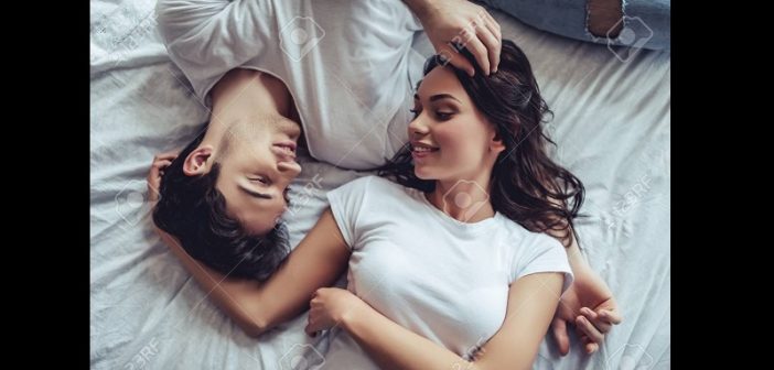 beautiful-young-couple-in-bedroom-is-lying-on-bed-enjoying-spending-time-together--702x336